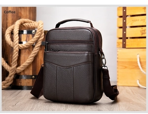 Detail view of coffee leather crossbody bag with three zipper layers and textured finish