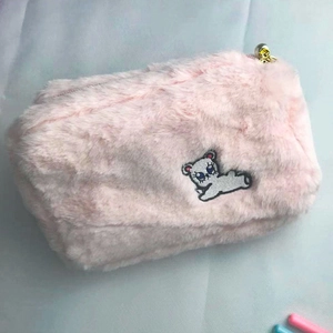 Pink plush makeup bag featuring cute embroidered bear and elegant pearl zipper detail