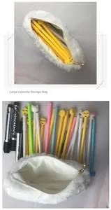 Macro detail of plush white pencil case featuring gold zipper and pearl decorative pendant