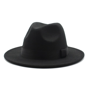 Detail of the black fedora hat with a classic teardrop crown and matching ribbon band