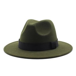 Detail of the olive green fedora hat featuring a black ribbon band and flat wide brim