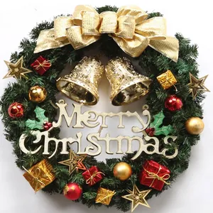 Traditional green Christmas wreath with golden bells, ornaments and Merry Christmas sign