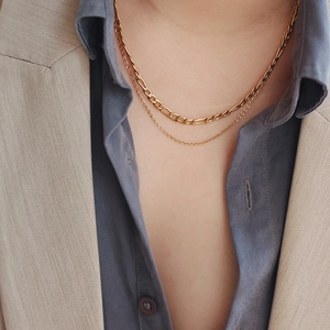Double layered gold Figaro chain necklace in stainless steel shown on model