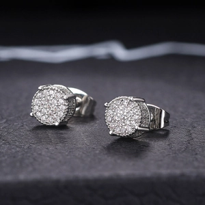 Macro detail of silver iced-out stud earrings with micro-pave cubic zirconia stones