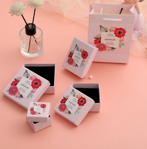 Matching set of pink floral jewelry boxes and gift bags with plush black lining