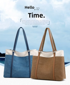 Detail view of large canvas tote bags with leather handles in blue and brown contrast