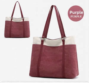 Detail view of canvas tote bag with contrast stitching in purple and beige