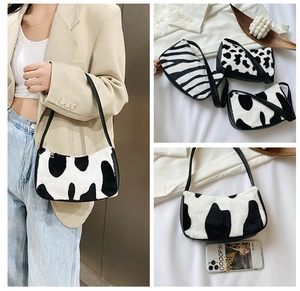 Three plush faux fur underarm bags in zebra and cow prints shown with leather straps