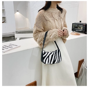Chic zebra pattern faux fur shoulder bag styled with beige knitwear and white skirt