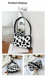 Detailed close-up of plush cow print underarm bag with black leather strap and silver zipper