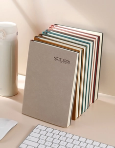 Executive A5 business notebooks in multiple colors displayed in a professional office setting