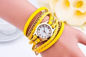 Close-up of a women's triple wrap bracelet watch featuring yellow woven leather and gold chains