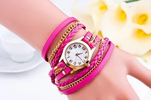 Close-up of bohemian multi-layer woven leather wrap watch with golden round dial for women