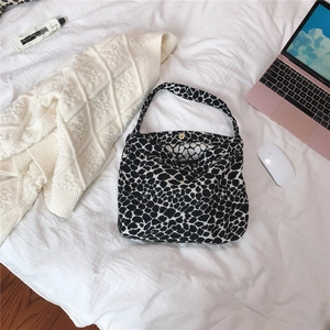 Detail of canvas tote with black and white stone pattern and gold magnetic clasp