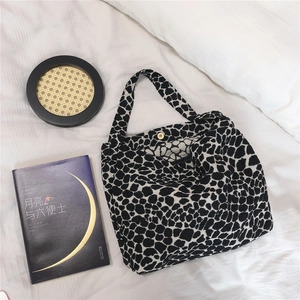 Detail of vintage leopard print shoulder bag with gold magnetic buckle closure