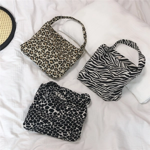 Detailed overhead view of animal print knit tote bags in leopard and zebra patterns