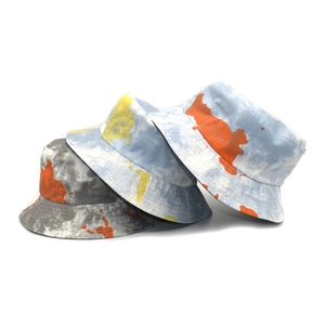 Reversible graffiti bucket hats with abstract splatter and map prints for outdoor sun shade