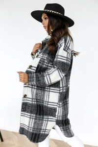 Detail of black and white plaid wool blend long coat with buttons and chest pockets