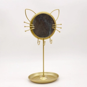 Golden cat-shaped metal jewelry organizer rack with round mirror and storage tray
