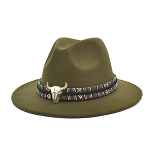 Dark green wide brim fedora hat with ethnic band and vintage golden bull skull ornament