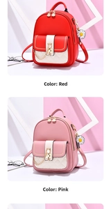 Detail view of red and pink PU leather backpacks with cat metal clasp and chain decor