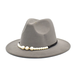 Detail of grey wool fedora hat with black band decorated with white pearls and gold rhinestones