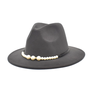 Detailed view of dark grey fedora hat with elegant pearl and rhinestone hatband trim