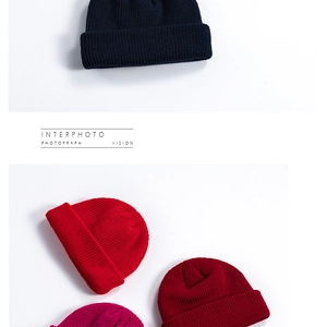 Detailed close-up of knitted cotton texture and vibrant multi-color yarn on beanie hats