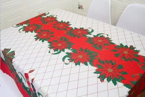 Festive rectangular Christmas tablecloth with red and green patterns on a long table
