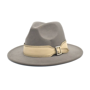 Detail of grey wool fedora hat with beige leather band and silver buckle accents