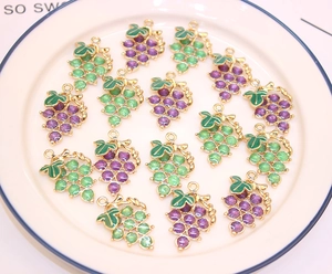 Detailed view of grape-shaped alloy charms with purple and green crystals for DIY jewelry