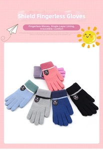 Detail of warm knitted gloves for children featuring a classic shield badge and ribbed cuffs