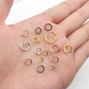 Close-up of mixed color open jump rings for DIY jewelry making in various metal finishes