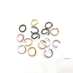 Close-up of mixed metal jump rings in silver, gold, and bronze for jewelry making