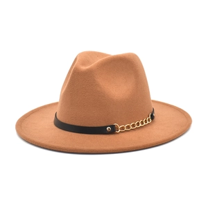 Detail view of camel fedora hat featuring a black belt band and gold chain accent