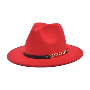 Close-up of red fedora hat with black leather strap and gold metal chain detail