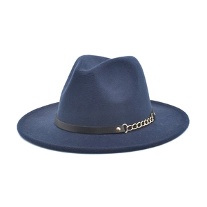 Detail of dark blue fedora hat with gold chain accent and leather belt band decoration