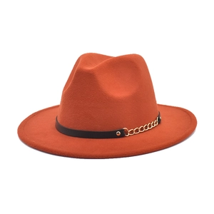 Detailed side view of orange-red wool fedora hat with black leather band and gold chain
