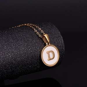 Golden stainless steel round pendant necklace with white shell inlay and letter D