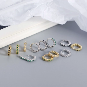 Detail of S925 sterling silver hoop earrings with gold plating and colorful zircon stones