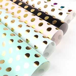 Polka dot gold foil gift wrapping paper rolls in mint, blue, pink, black, and white