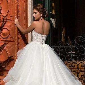 Elegant off-shoulder white lace wedding dress with ball gown skirt and lace-up back