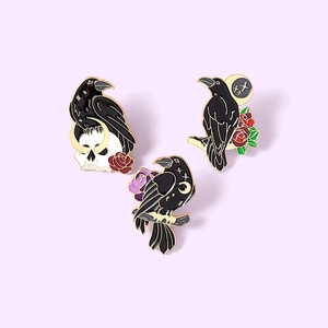 Gothic black crow enamel pins set featuring skull, rose, and moon elements in gold trim