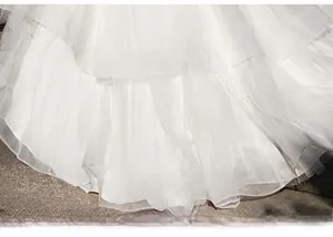 Detail of layered white tulle wedding dress hem with sparkling sequins and glitter