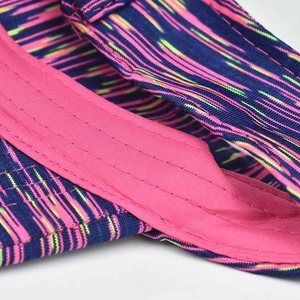 Macro detail of navy sun visor with pink stitching and vibrant knit texture