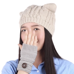 Detail of cream cable-knit cat ear hat and grey fingerless gloves with wood buttons