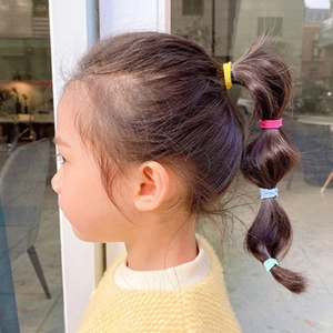 Close-up of colorful high-elastic hair ties used for styling children lantern braids