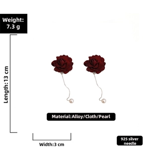 Detail view of red rose earrings with silver chains, pearls and size dimensions