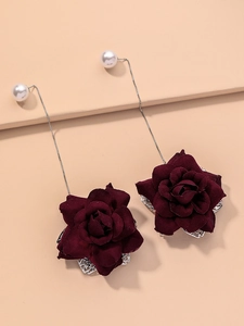 Detail view of long drop earrings with white pearls and burgundy fabric roses