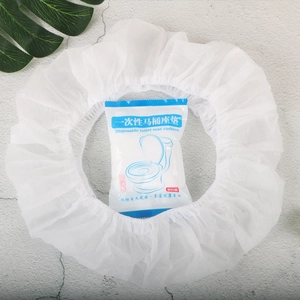 Individual disposable toilet seat cover in sterile packaging on a clean grey background